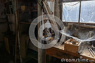 Old dusty DIY workshop abandoned with cobwebs, as if frozen in time. Stock Photo