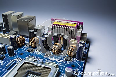 The old and dusty motherboard from the computer. Blue color. Switches. Details from the personal computer. Repair. Dust. Editorial Stock Photo