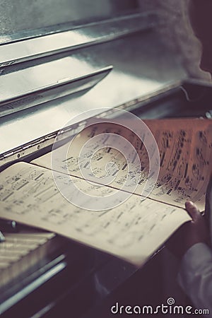 Old dusty notes on a vintage piano Stock Photo