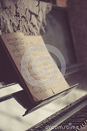 Old dusty notes on a vintage piano. Stock Photo