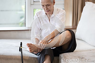 Old elderly with foot injuries,ankle bone diseases,heel pain or soles,asian senior woman suffering from peripheral neuropathy, Stock Photo