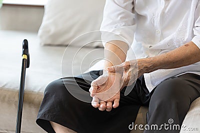 Old elderly people with wrist injury,bone pain in wrist,numbness or beriberi,asian senior woman suffering from De quervain`s Stock Photo