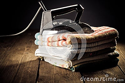 Old electric iron on the wooden background Stock Photo