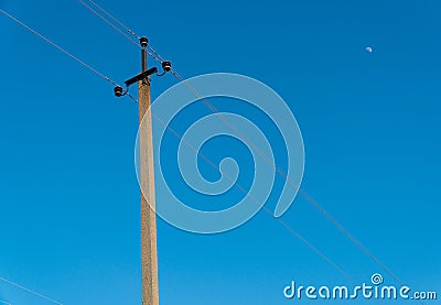 Old electric pole with wires used for electricity traffic with clear blue sky. Power electric pole Stock Photo