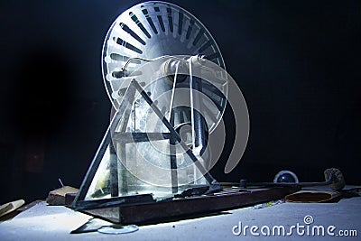 Old electrostatic machine, Wimshurst generator and glass pyramid on black background. Physics education concept Stock Photo