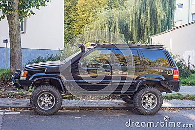 Old but elegant Jeep Grand Cherokee high suspension parked Editorial Stock Photo