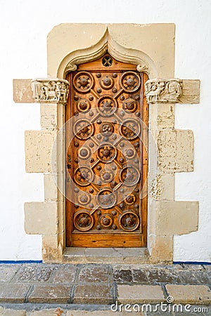 Old entrance door of an ancient building with a graceful pattern Stock Photo