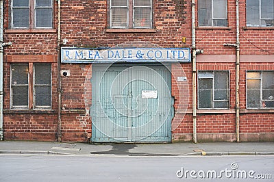 An old entrance gate to a local business in UK Editorial Stock Photo