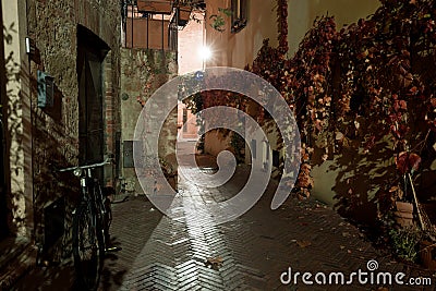 Old European narrow empty street of a medieval town at evening. Stock Photo