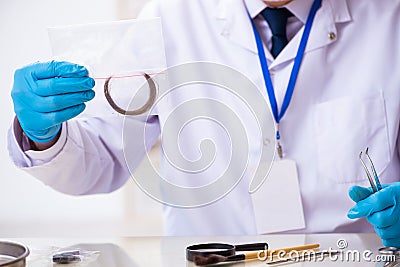 Old male expert criminologist working in the lab for evidence Stock Photo