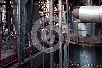 Old factory chemical plant metal structures. Industrial plant with rusty pipes and thermal insulation. Production obsolescence Stock Photo