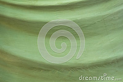 Old faded green fabric with folds. rough surface texture Stock Photo