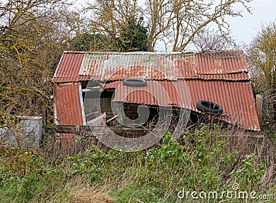 Old falling down, abandoned corrugated shed in the countryside Editorial Stock Photo