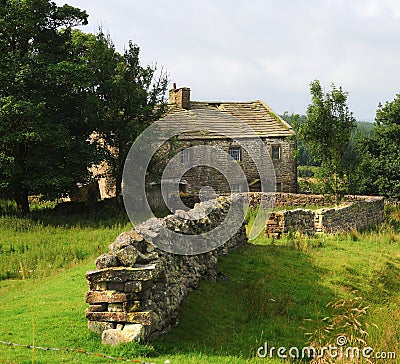 Old farmhouse and dry stone walls. Stock Photo