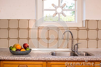 Old Farmhouse Kitchen Sink and Faucet vintage design with pattern tiles and cozy window Stock Photo