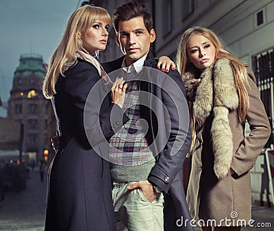 Old fashion man with company of two cute women Stock Photo