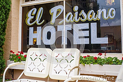 Old fashion metal lawn chairs decorate the patio of the historic El Paisano Hotel in Marfa, Texas. Editorial Stock Photo