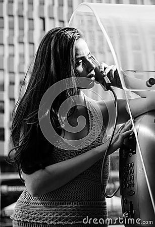 Old fashion town. Vintage concept. Woman with payphone. Communication. Oldstyled city. Stock Photo