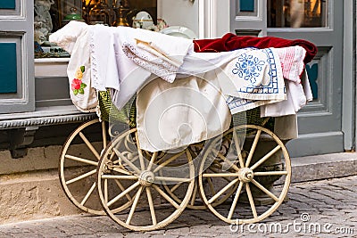 Old-fashioned baby carriage with wooden wheels Stock Photo