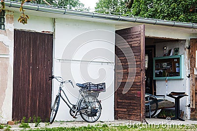 Old fashioned bicycle and a small garage Stock Photo