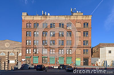 Old-fashioned brickwall factory building against a blue sky on a beautiful sunny day in the Bronx, New York Stock Photo
