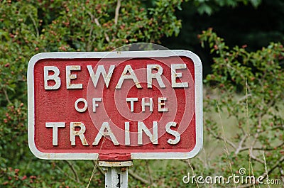 Old fashioned cast iron Beware of Trains sign Stock Photo