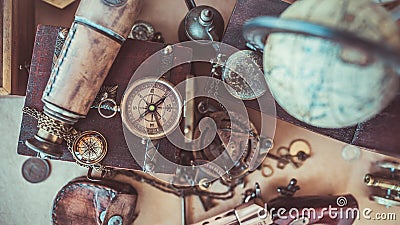 Old-fashioned compass, telescope on old world map Stock Photo