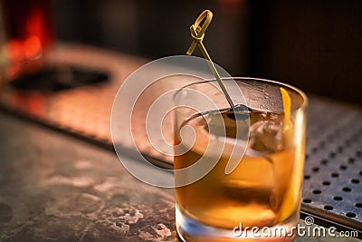 Old Fashioned drink at a bar, with olive Stock Photo