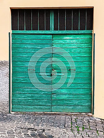Old fashioned green garage door Stock Photo