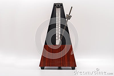 Old fashioned musical metronome isolated on a white background Stock Photo