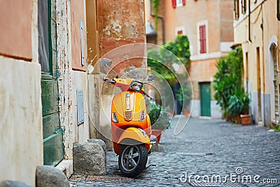 Old fashioned orange motorbike on a street of Trastevere district, Rome Editorial Stock Photo