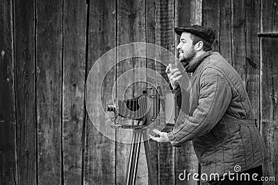 Old fashioned photographer asks for a smile. Works on large format camera. Idea - photography of the 1930s-1950s Stock Photo