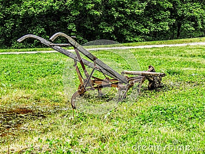 Old fashioned plough in a field Stock Photo