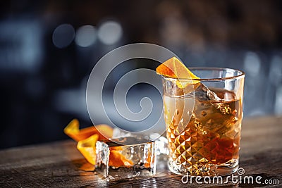 Old fashioned rum drink on ice with orange zest garnish Stock Photo