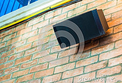 Old-fashioned speakers mounted on a brick wall Stock Photo