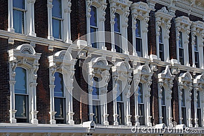 building facade with ornate window frame mouldings Stock Photo