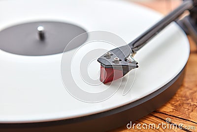 Old-fashioned turnable record player on a wooden background. Stock Photo