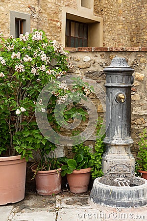 Old fashioned water fountain in the Tuscan hillside town of Barberino Val D`Elsa. Stock Photo