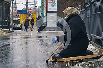 Old female beggar asking for money on Moscow street in winter Editorial Stock Photo