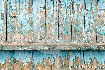 The old fence boards with chink. Painted light blue paint. Stock Photo