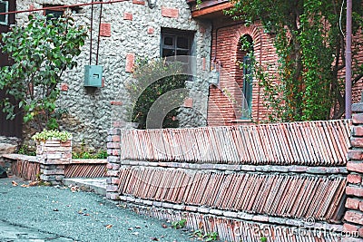 Old fence made of clay tiles Stock Photo