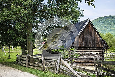 Fenced log house Stock Photo