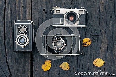 Old film camera on grunge dark wooden background Stock Photo