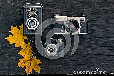 Old film camera on grunge dark wooden background Stock Photo