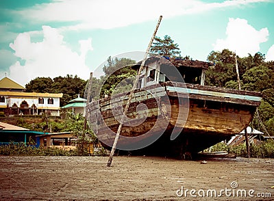 Old fishing boat that have been abandoned at Malaysian beach Editorial Stock Photo