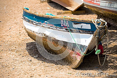 Old fishing boat on the shore. Boat with nets waiting for fishermen on the beach of Cape Verde Editorial Stock Photo