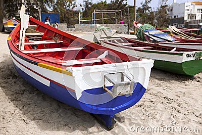 Old fishing boat on the shore. Boat with nets waiting for fishermen on the beach of Cape Verde Editorial Stock Photo