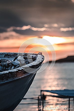 Old fishing boat on sunset, vertical Stock Photo