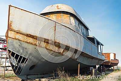 Old fishing boats on land for repair Stock Photo