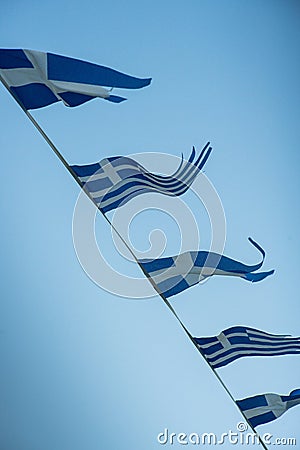 Greek flags in the wind Stock Photo